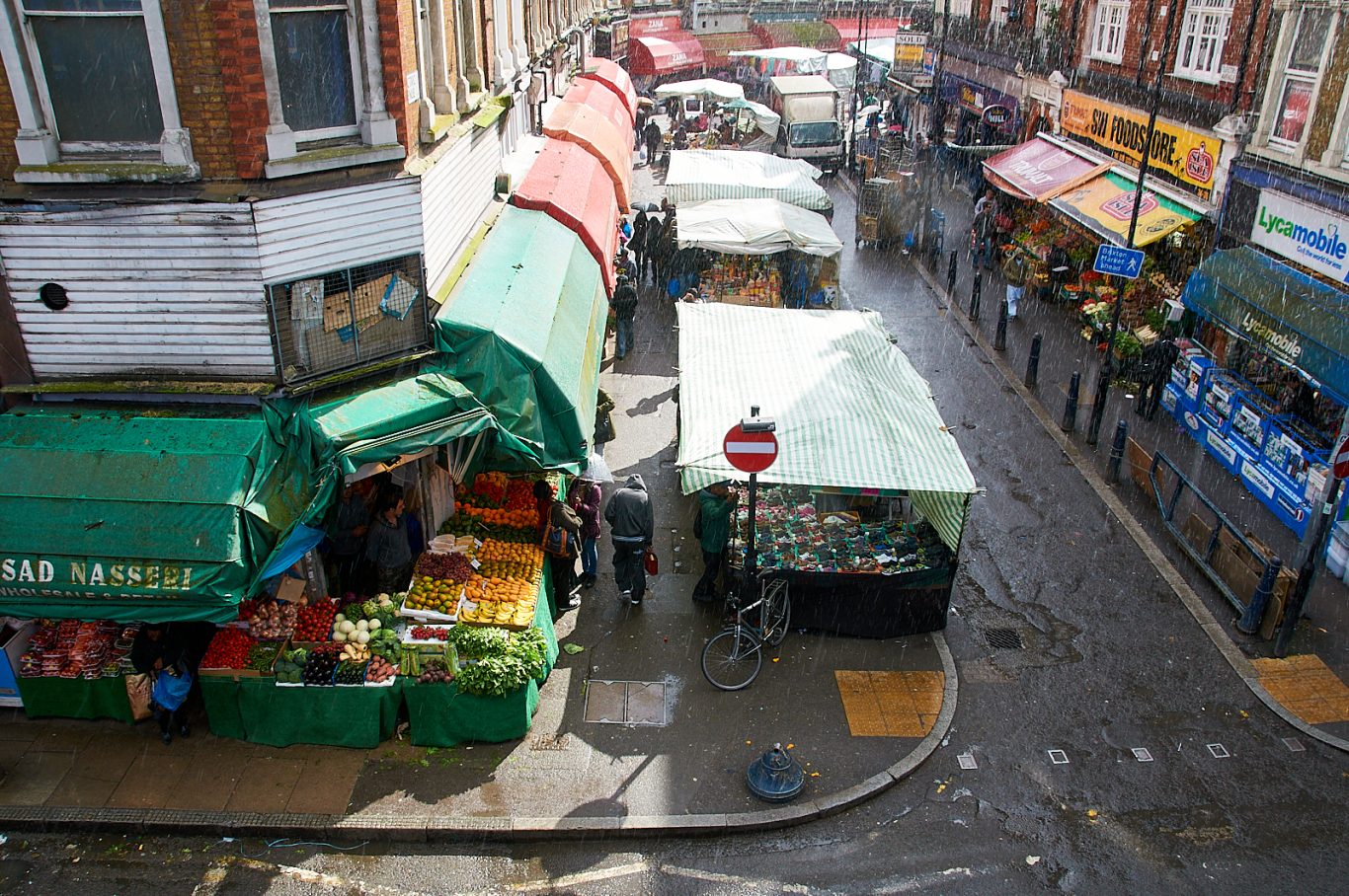 18. A spring shower, Brixton Market, Electric Avenue, London. 10th May 2014.